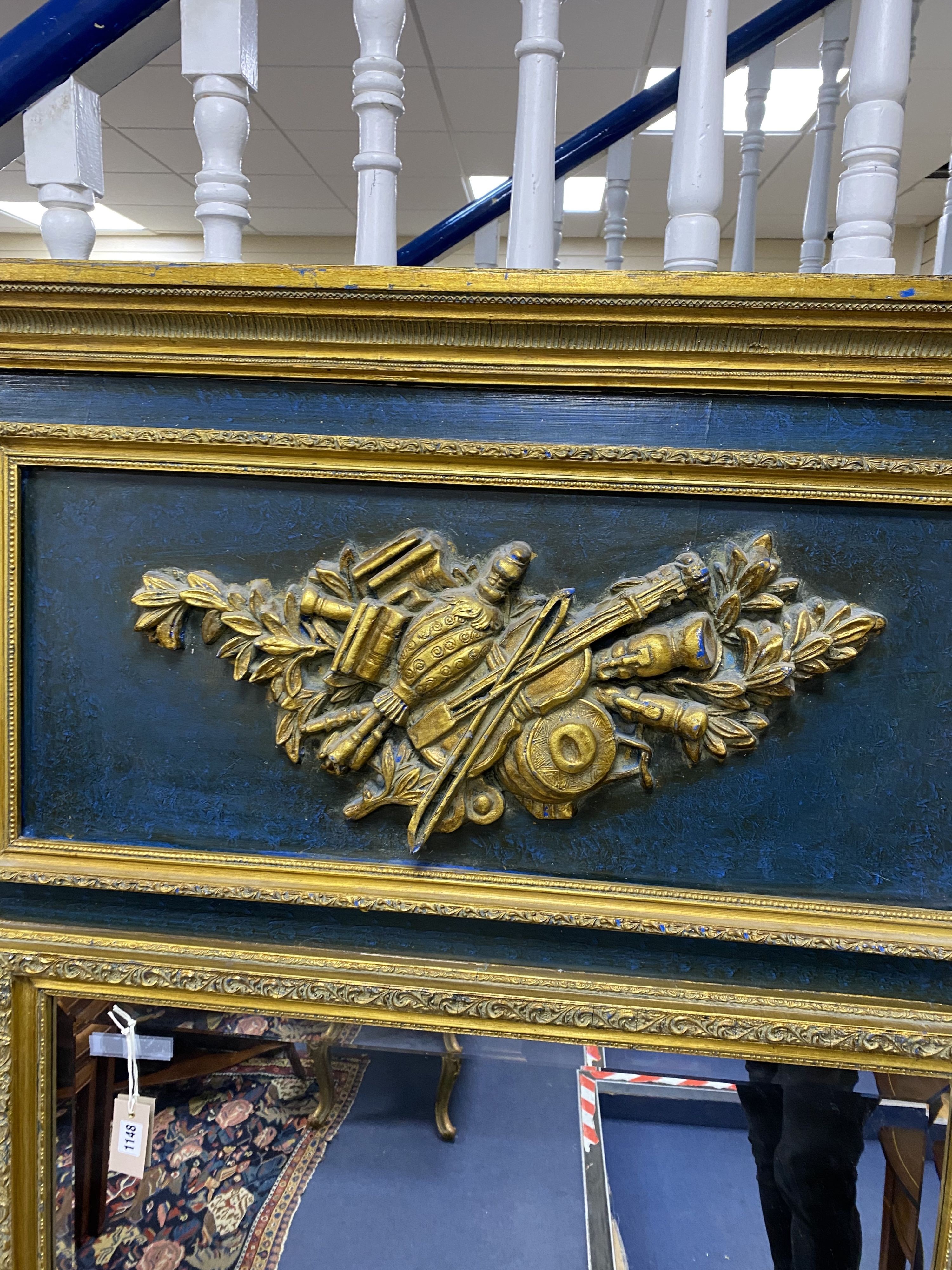 A 19th century French overmantel gilt and gesso mirror with musical themed emblem over on blue background, width 114cm, height 172cm